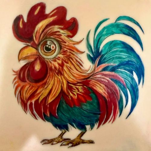 A rooster in vivid red, orange and teal, tattooed in full colour on a TrueSkin sheet.